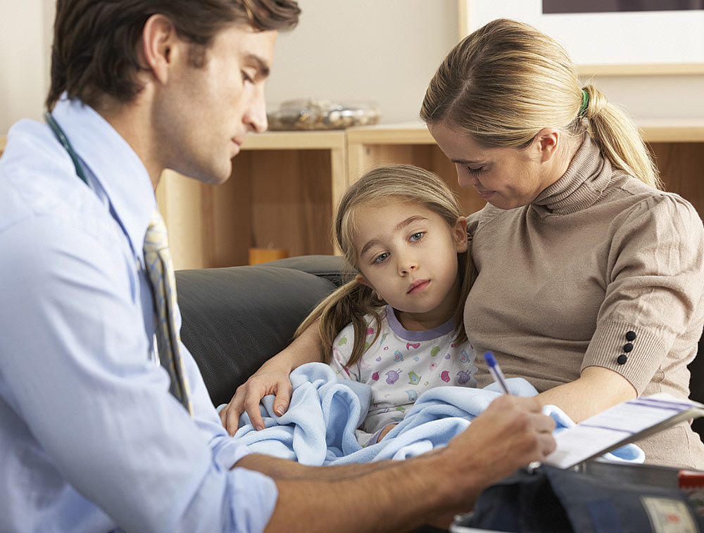 Doctor speaking with a mother and daughter